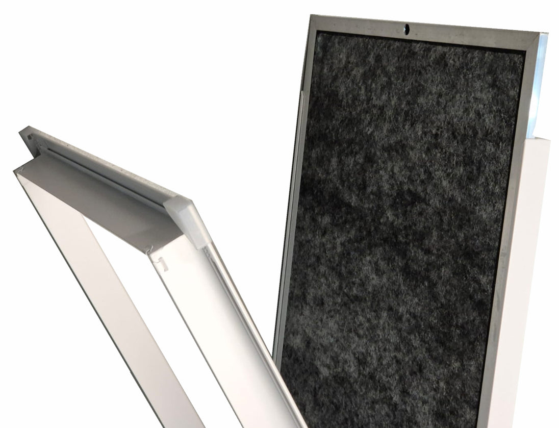 A close-up of a rectangular panel with a dark textured surface and a light gray frame, shown alongside a matching angled view of the frame on a white background.

