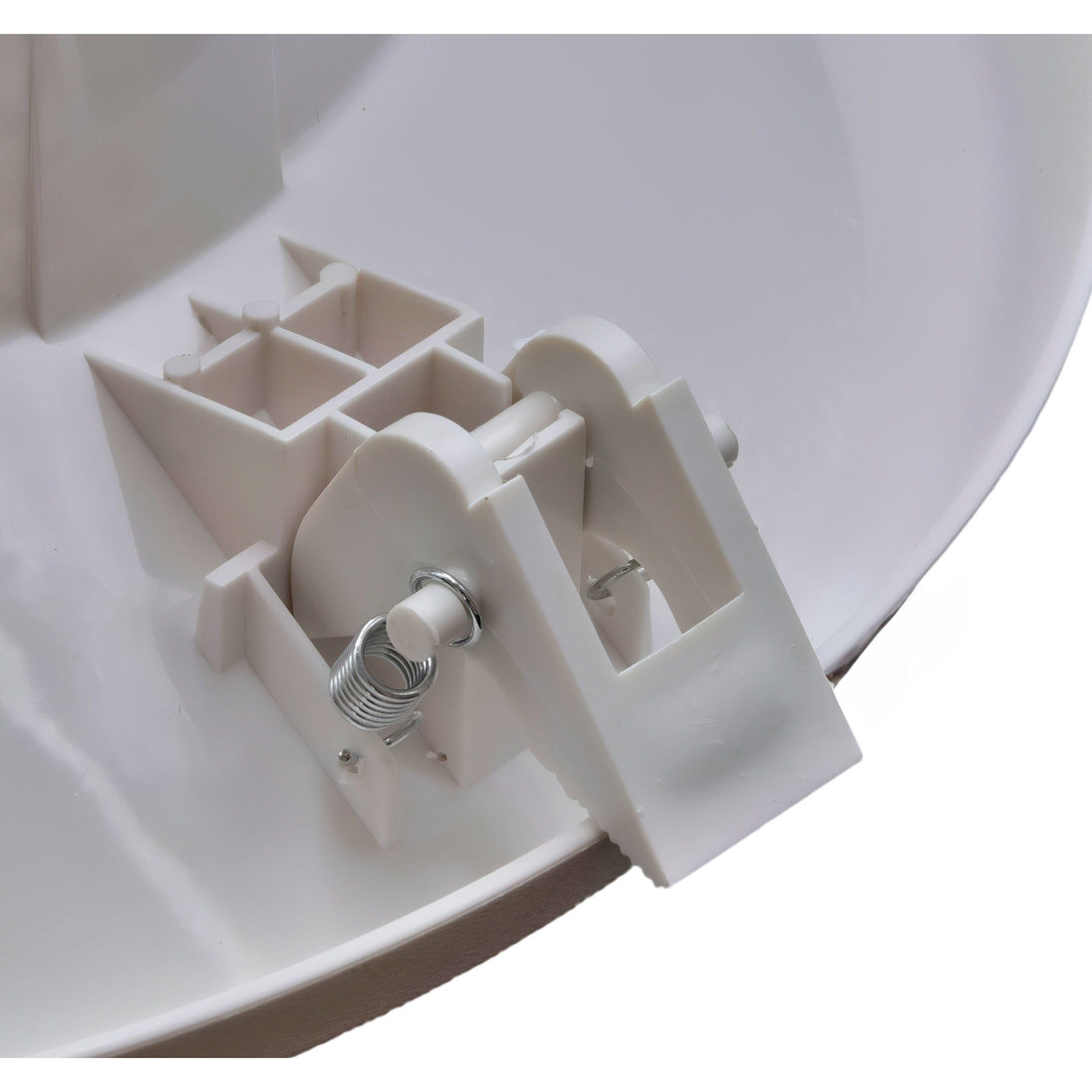 Close-up of a white plastic bracket on a curved white surface

